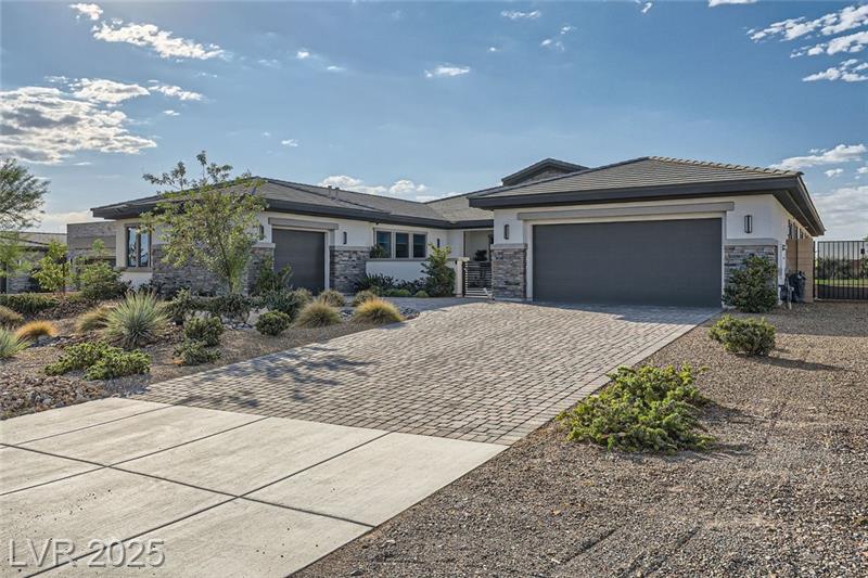 Exterior view of a modern custom home at 9475 West Rosada Way in Las Vegas with pool and mountain views