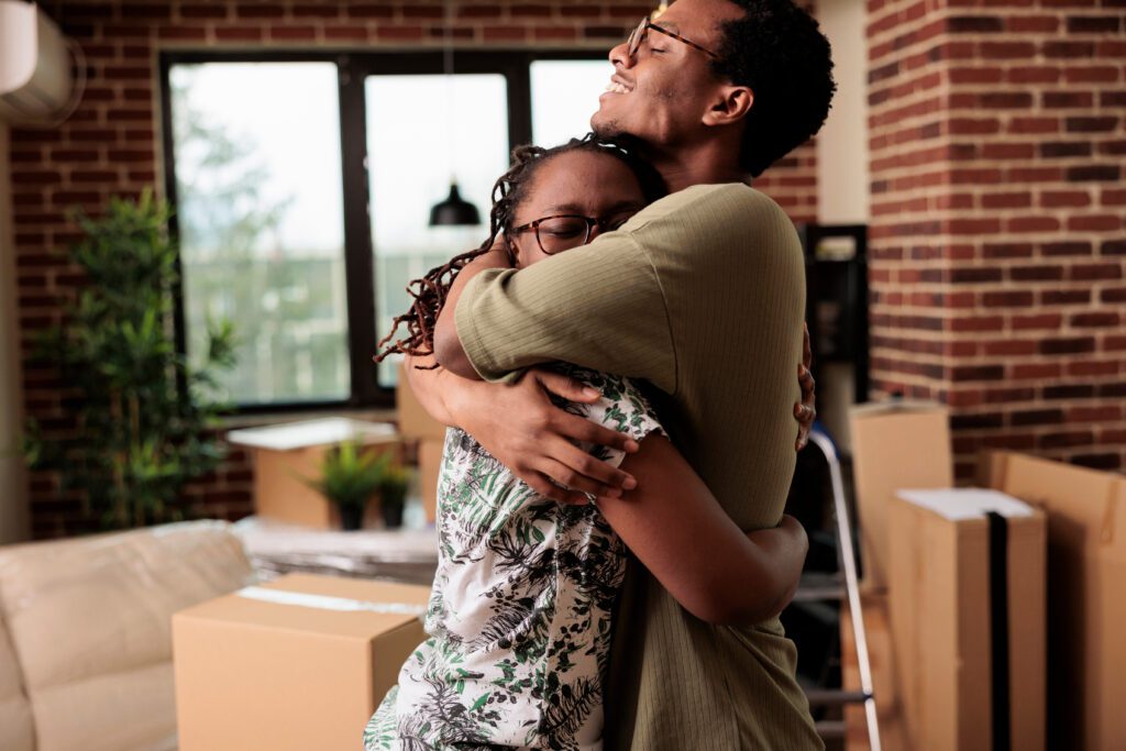 African American couple hugging joyfully in their new Las Vegas home, exemplifying the success of a fast mortgage approval and quick move-in.
