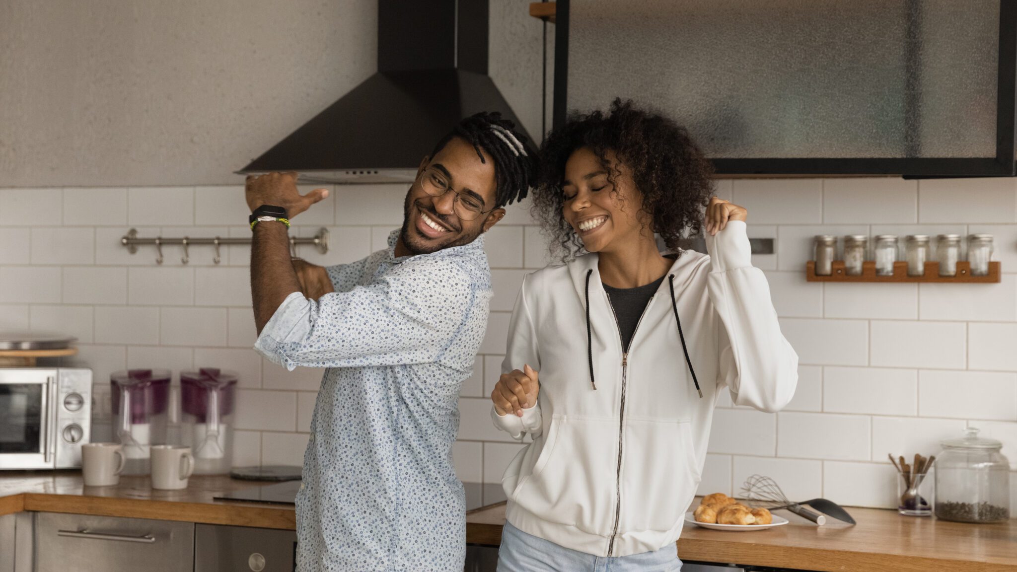 Happy couple celebrating in their kitchen after selling their Las Vegas home quickly for top dollar.