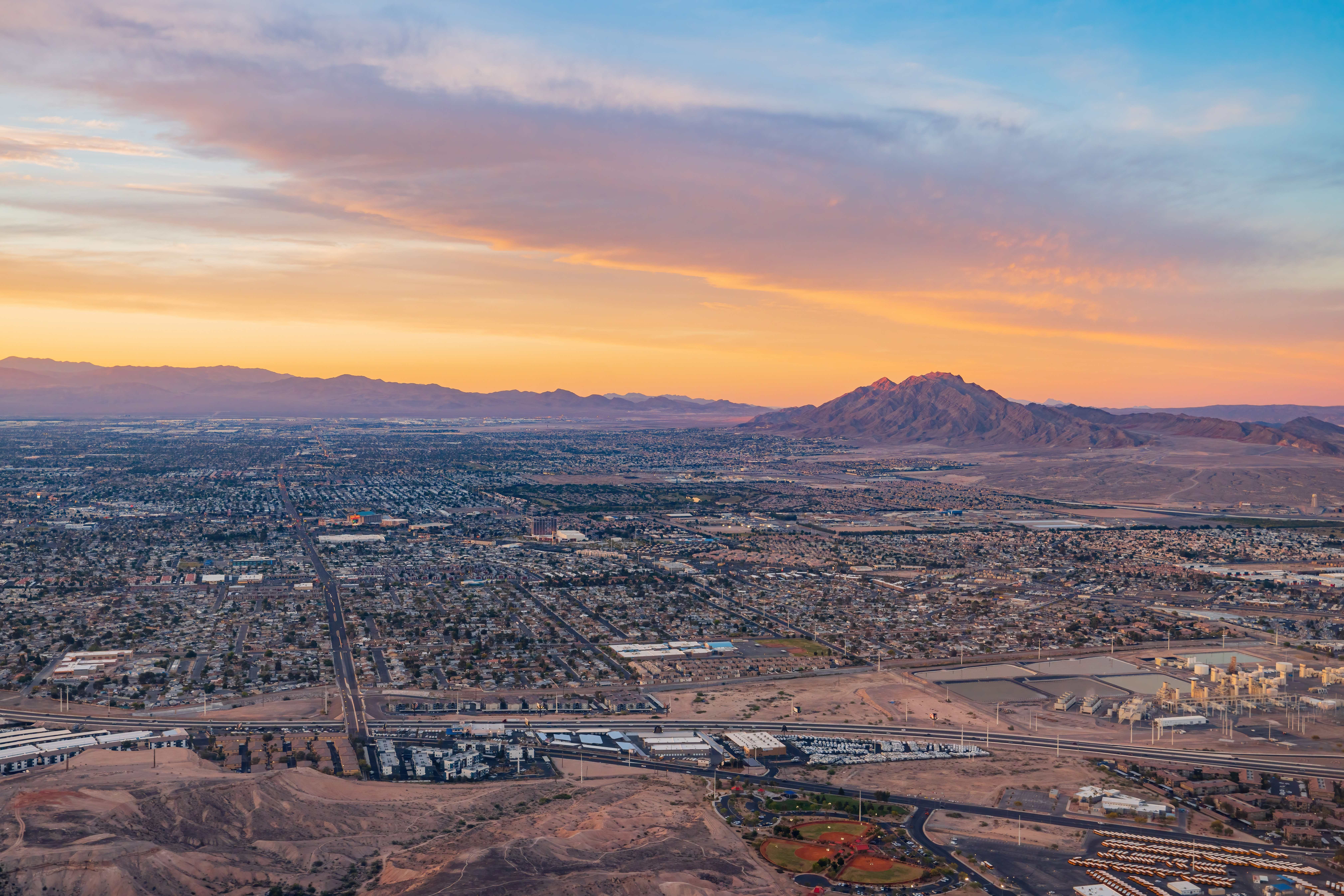 Aerial view of Las Vegas at sunset, highlighting the diverse neighborhoods and communities in the city.
