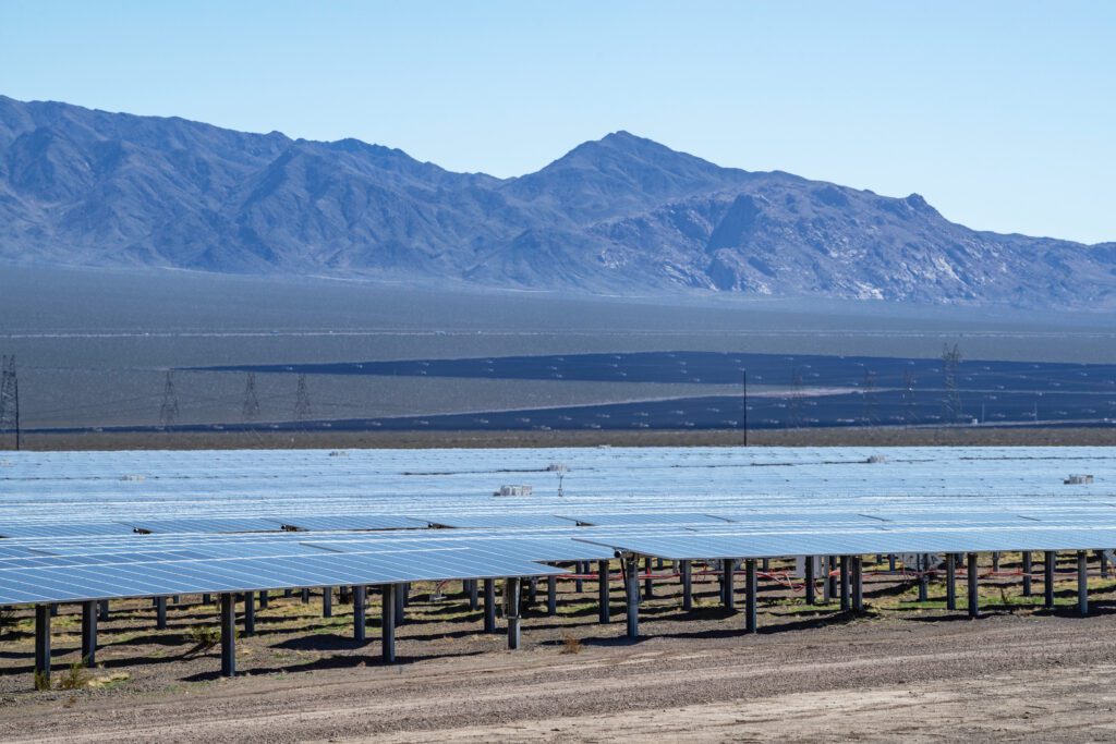 Utility-scale solar power panels in Eldorado Valley, Boulder City, Nevada, reflecting heat waves and generating clean renewable energy.