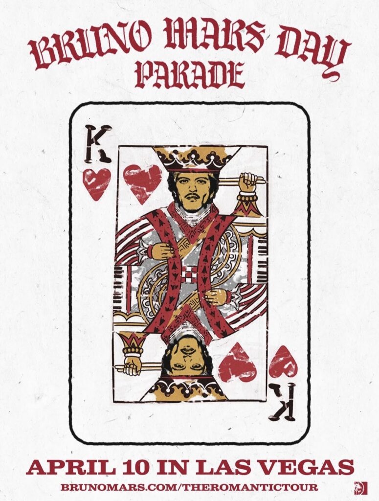 A graphic poster designed as a textured, aged King of Hearts playing card, featuring an illustration of Bruno Mars as the symmetrical, two-headed 'King' figure. He holds a drumstick over one shoulder. Red Old English style text at the top reads 'BRUNO MARS DAY PARADE'. The bottom reads 'APRIL 10 IN LAS VEGAS' and provides the official tour website. The card is set against a textured, light off-white background.