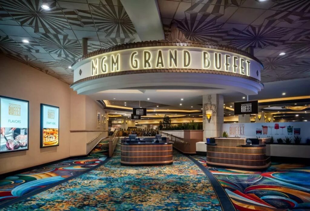 The main entrance of the MGM Grand Buffet in Las Vegas, featuring its iconic circular neon signage and warm interior lighting.