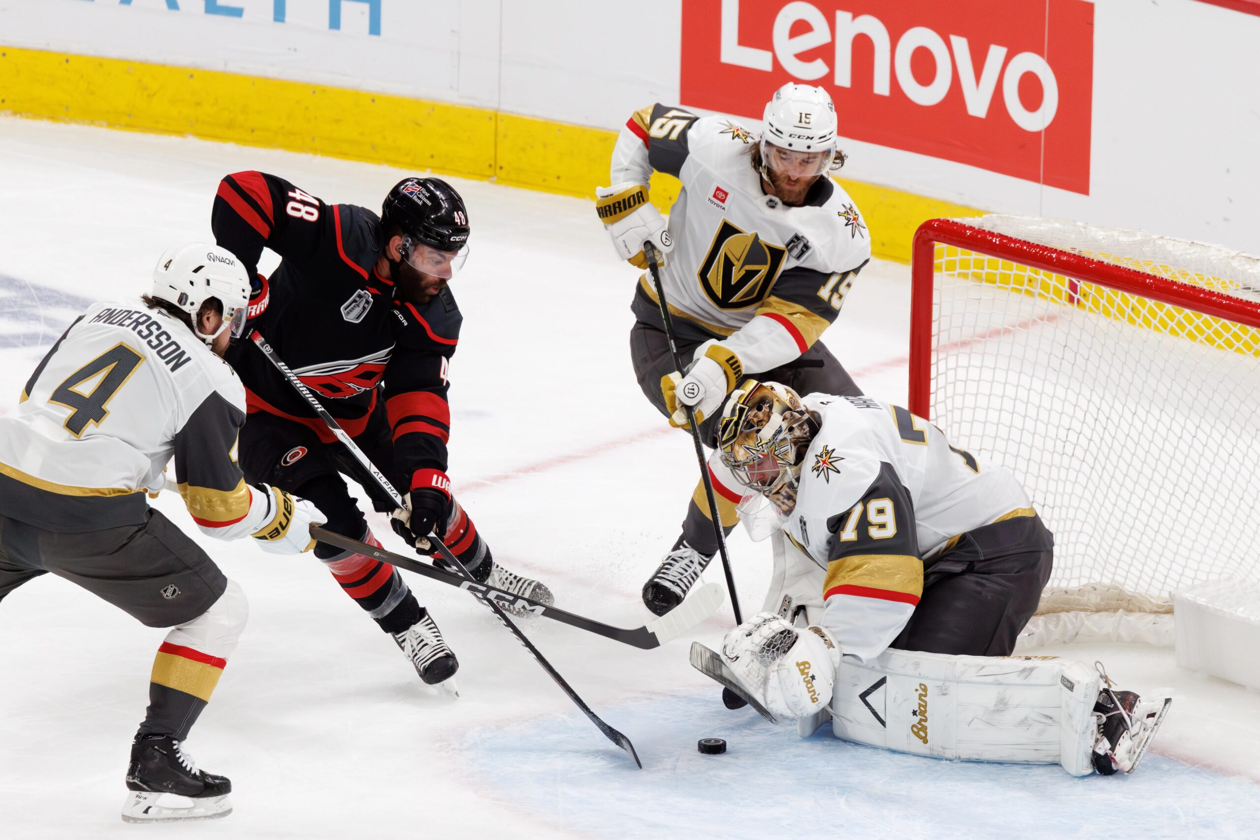 Vegas Golden Knights players Noah Hanifin and Carter Hart defending the net against the Carolina Hurricanes during the 2026 Stanley Cup Finals.