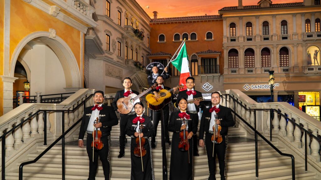 Traditional Mexican mariachi band in full charro attire posing on the grand staircase in St. Mark's Square at Grand Canal Shoppes inside The Venetian Resort Las Vegas for Hispanic Heritage Month.