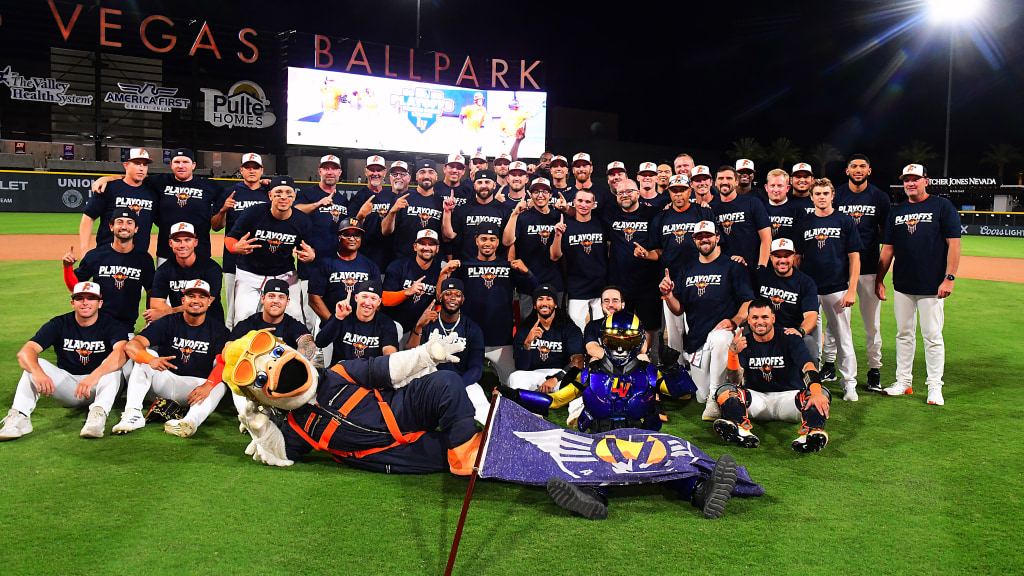 The Las Vegas Aviators team, coaches, and team mascot celebrating on the field at Las Vegas Ballpark wearing playoff shirts.