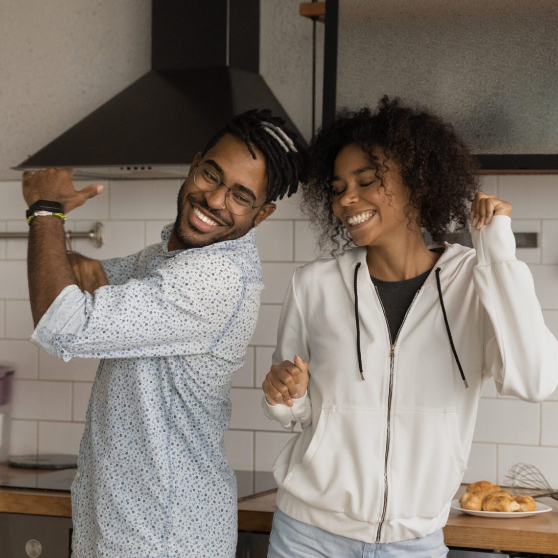 Happy couple celebrating in their kitchen after selling their Las Vegas home quickly for top dollar.